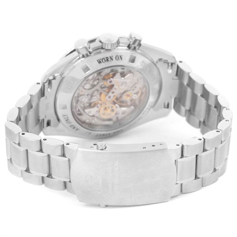 The image shows the back case and bracelet clasp of an Omega Speedmaster 311.30.42.30.13.001 Men's Stainless Steel Brown Dial 311.30.42.30.13.001 Men's Stainless Steel Brown Dial watch, highlighting the movement through the transparent case back.