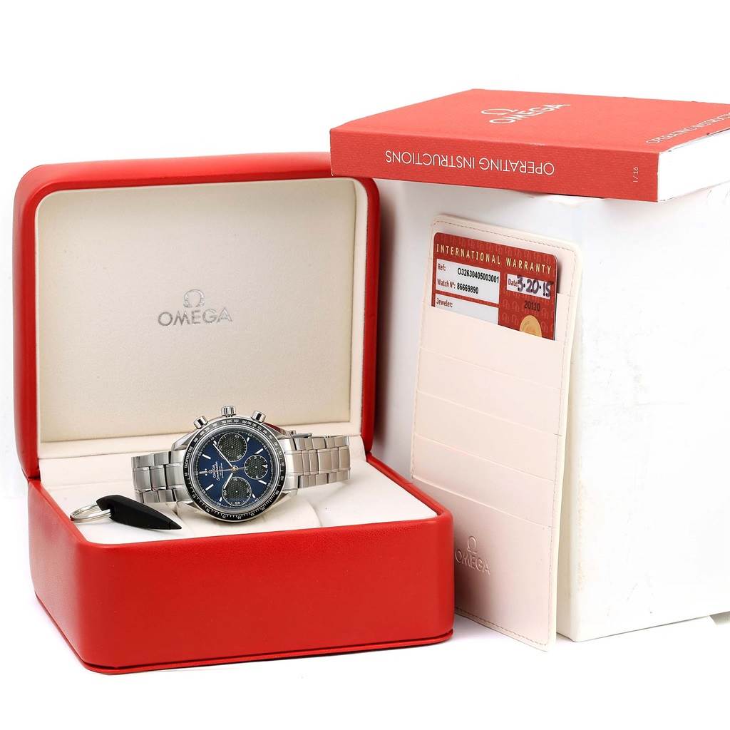 The Omega Speedmaster 326.30.40.50.03.001 Men
s Stainless Steel Blue Dial 326.30.40.50.03.001 Men
s Stainless Steel Blue Dial watch is displayed in its open case, alongside its warranty card and instruction manual.