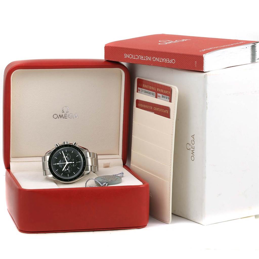 The Omega Speedmaster 311.30.44.50.01.002 Men's Stainless Steel Black Dial 311.30.44.50.01.002 Men's Stainless Steel Black Dial watch is displayed front-facing in its open red box, alongside a warranty card and an instruction booklet.