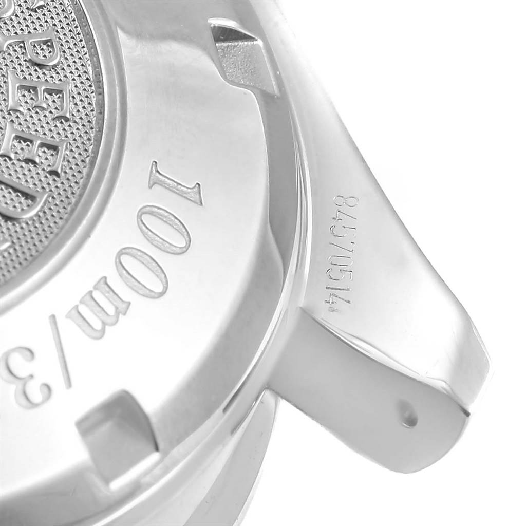 The image shows the case back and part of the strap attachment of an Omega Speedmaster 3210.52.00 Men
s Stainless Steel Black Dial 3210.52.00 Men
s Stainless Steel Black Dial watch.