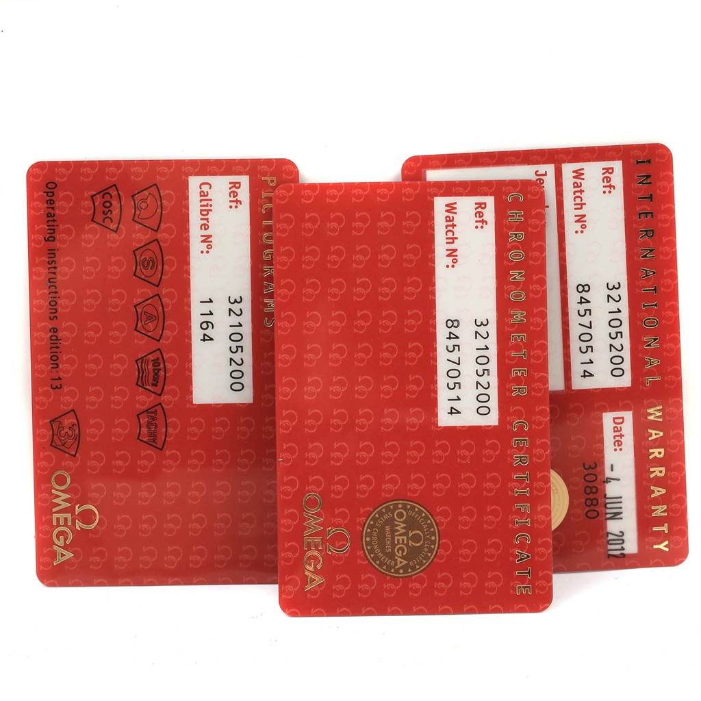 This image shows three Omega Speedmaster 3210.52.00 Men
s Stainless Steel Black Dial 3210.52.00 Men
s Stainless Steel Black Dial warranty cards from an overhead angle.