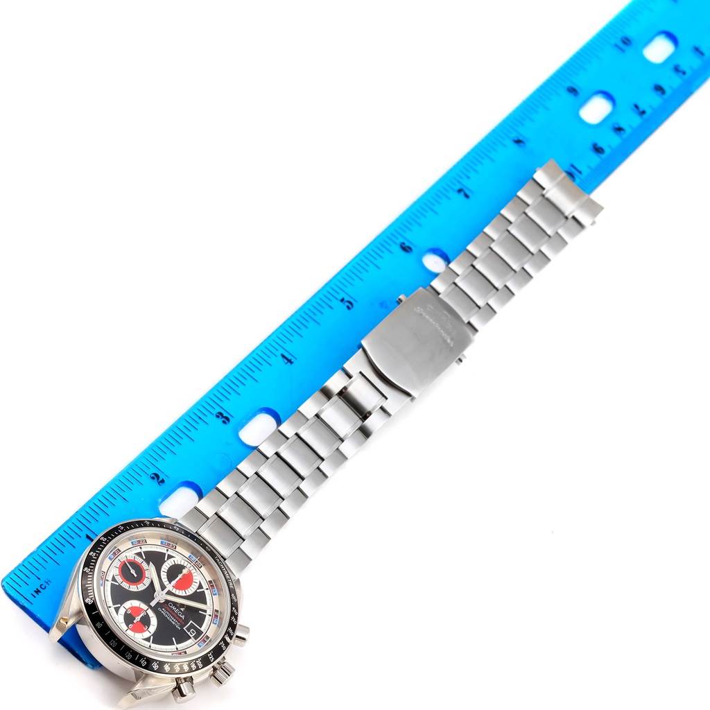 The Omega Speedmaster 3210.52.00 Men
s Stainless Steel Black Dial 3210.52.00 Men
s Stainless Steel Black Dial watch is shown from the top, laying flat with a blue ruler beside it, displaying its face and metal band.