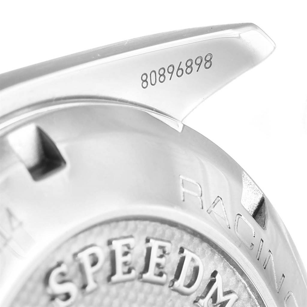 This image shows a close-up of Omega Speedmaster 326.30.40.50.03.001 Men's Stainless Steel Blue Dial 326.30.40.50.03.001 Men's Stainless Steel Blue Dial's case back and lug, highlighting the serial number and part of the engraved design.