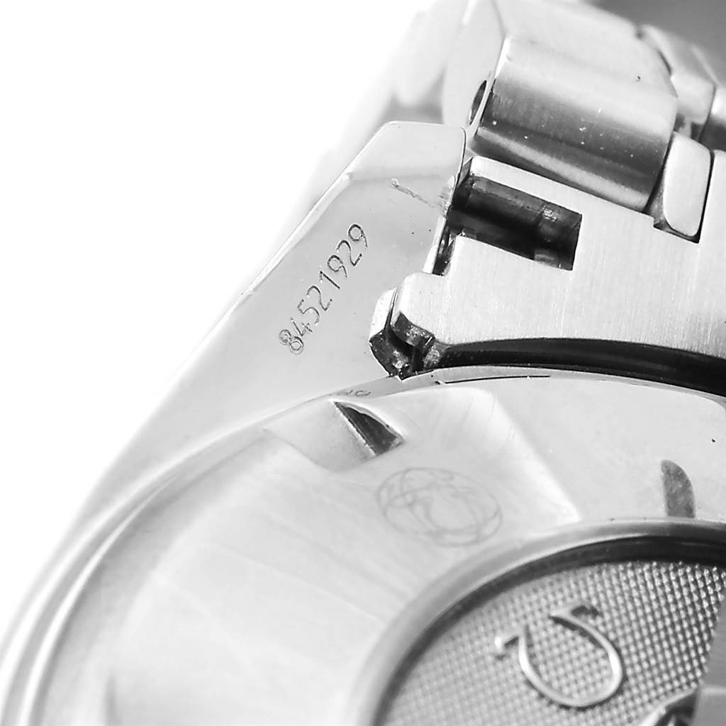 The image shows a close-up of the clasp and part of the bracelet of an Omega Speedmaster 3210.51.00 Men
s Stainless Steel Black Dial 3210.51.00 Men
s Stainless Steel Black Dial watch, including a visible serial number.