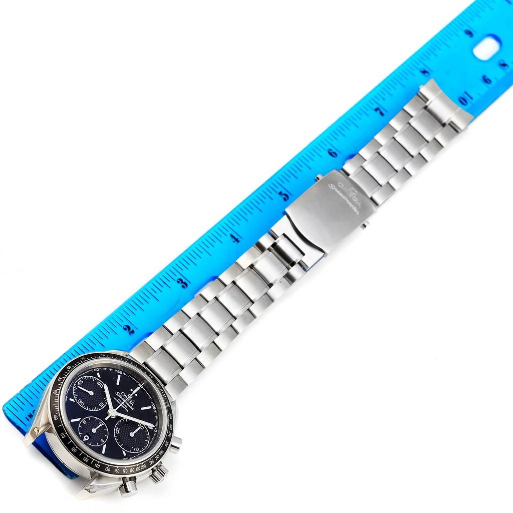 The Omega Speedmaster 326.30.40.50.01.001 Men
s Stainless Steel Black Dial 326.30.40.50.01.001 Men
s Stainless Steel Black Dial watch is shown from a top-down angle, with its dial, bracelet, and clasp visible alongside a ruler for scale.