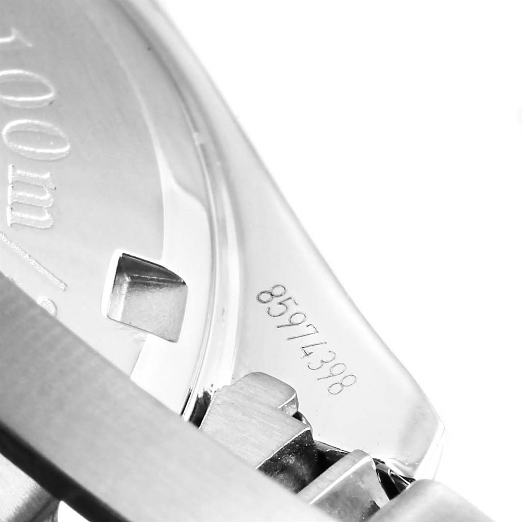 This close-up image shows the serial number and part of the back casing of the Omega Speedmaster 3210.52.00 Men
s Stainless Steel Black Dial 3210.52.00 Men
s Stainless Steel Black Dial watch.