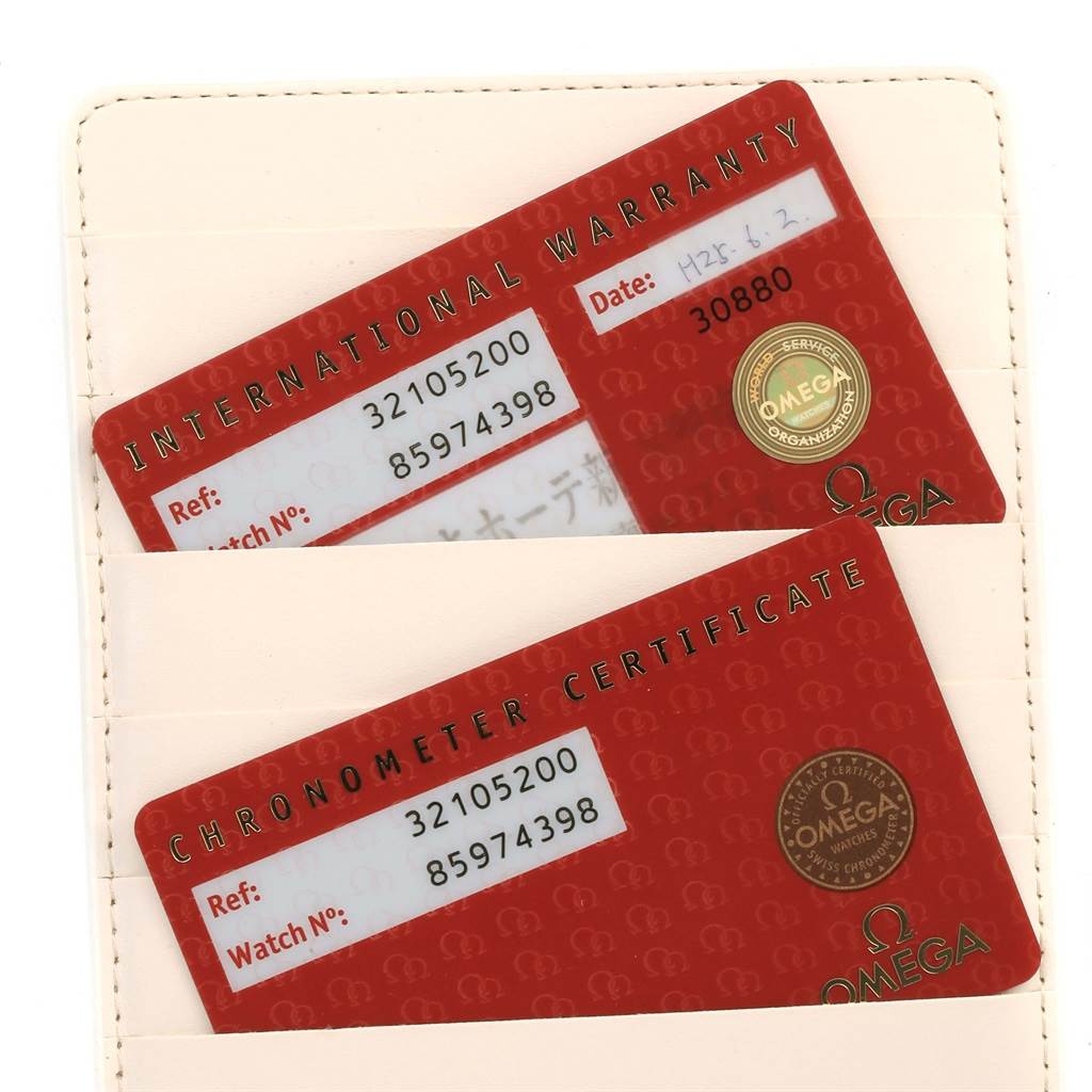 The image shows two Omega Speedmaster 3210.52.00 Men
s Stainless Steel Black Dial 3210.52.00 Men
s Stainless Steel Black Dial model cards: an International Warranty and a Chronometer Certificate, placed in a cardholder.