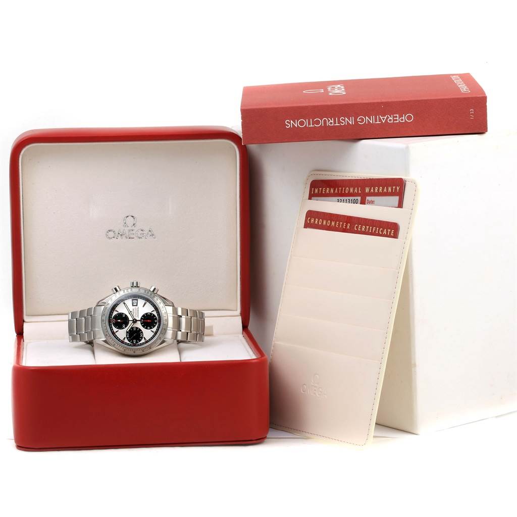This image shows an Omega Speedmaster 3211.31.00 Men
s Stainless Steel Silver Dial 3211.31.00 Men
s Stainless Steel Silver Dial watch in its box, with operating instructions and warranty certificate displayed.