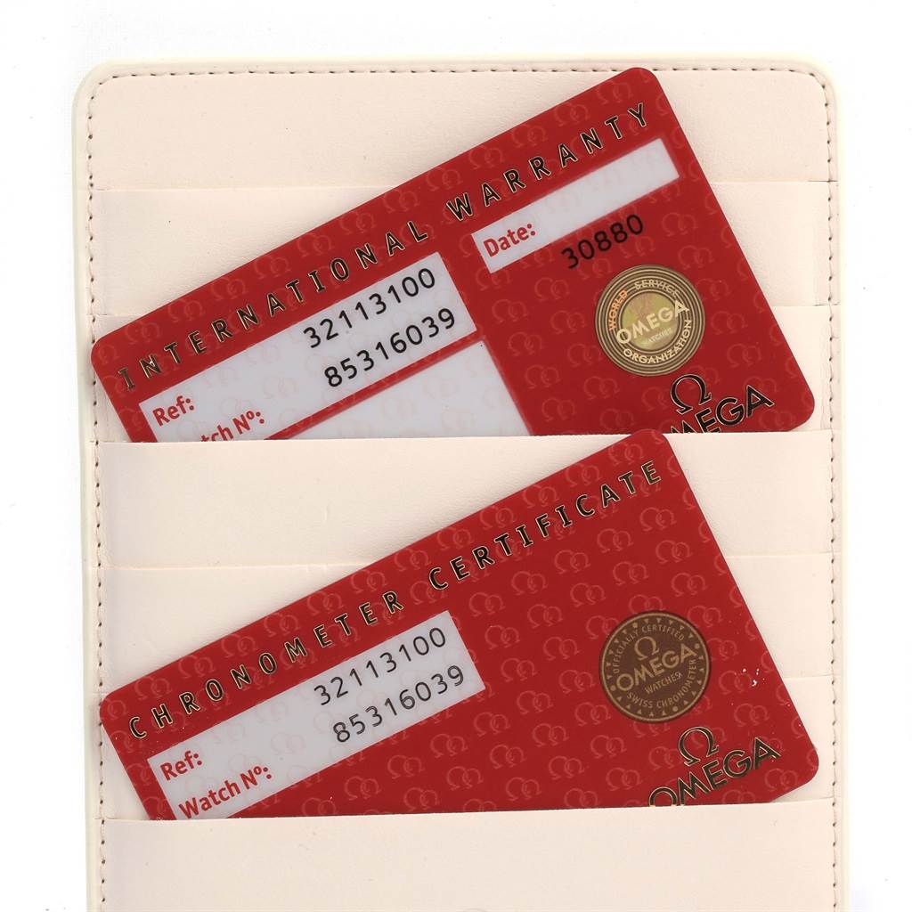 The image shows international warranty and chronometer certificate cards for an Omega Speedmaster 3211.31.00 Men
s Stainless Steel Silver Dial 3211.31.00 Men
s Stainless Steel Silver Dial watch.