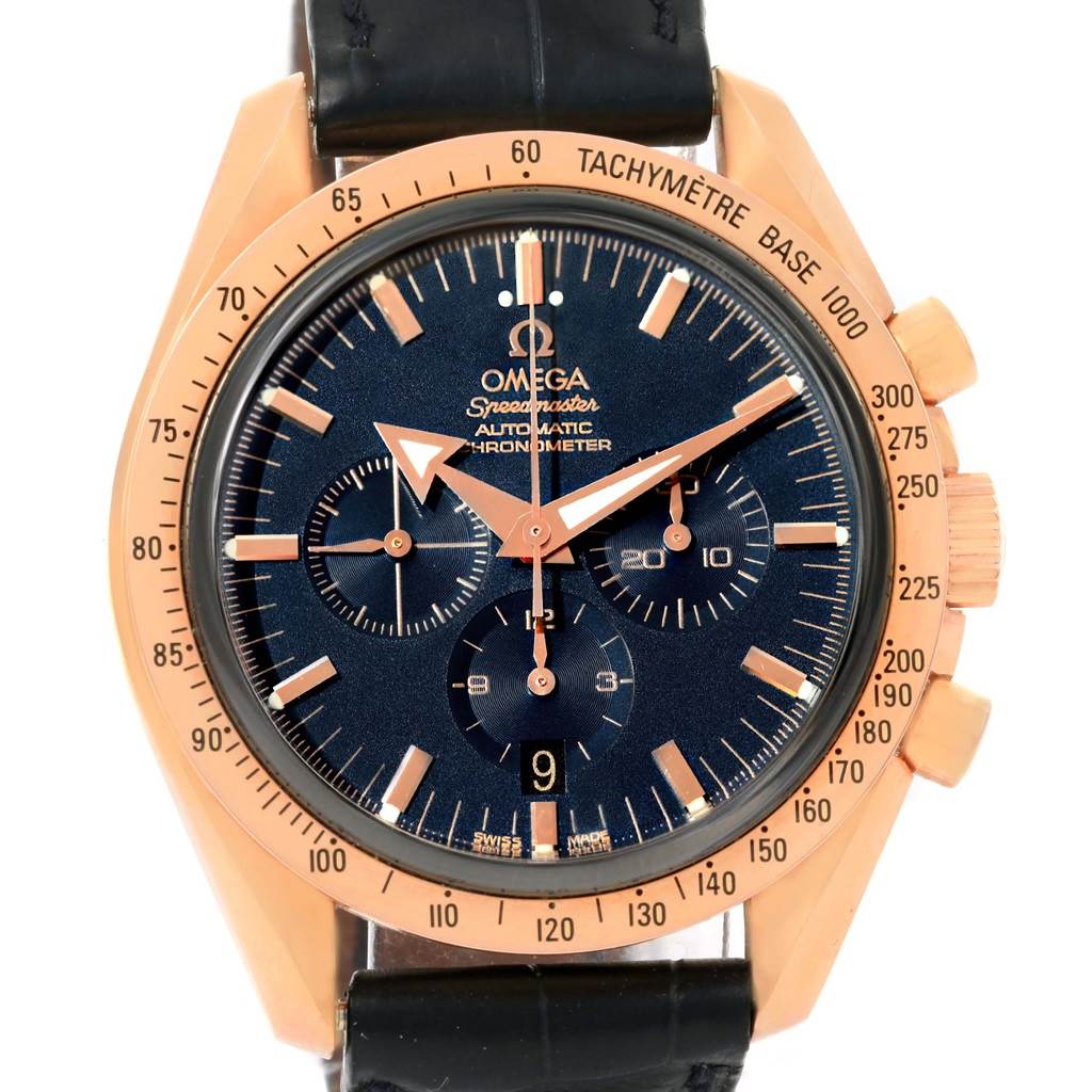 The image shows a front view of the Omega Speedmaster 178.0022 Men's Blue Dial 178.0022 Men's Blue Dial watch, highlighting its black dial, gold bezel, chronograph subdials, and tachymeter scale.