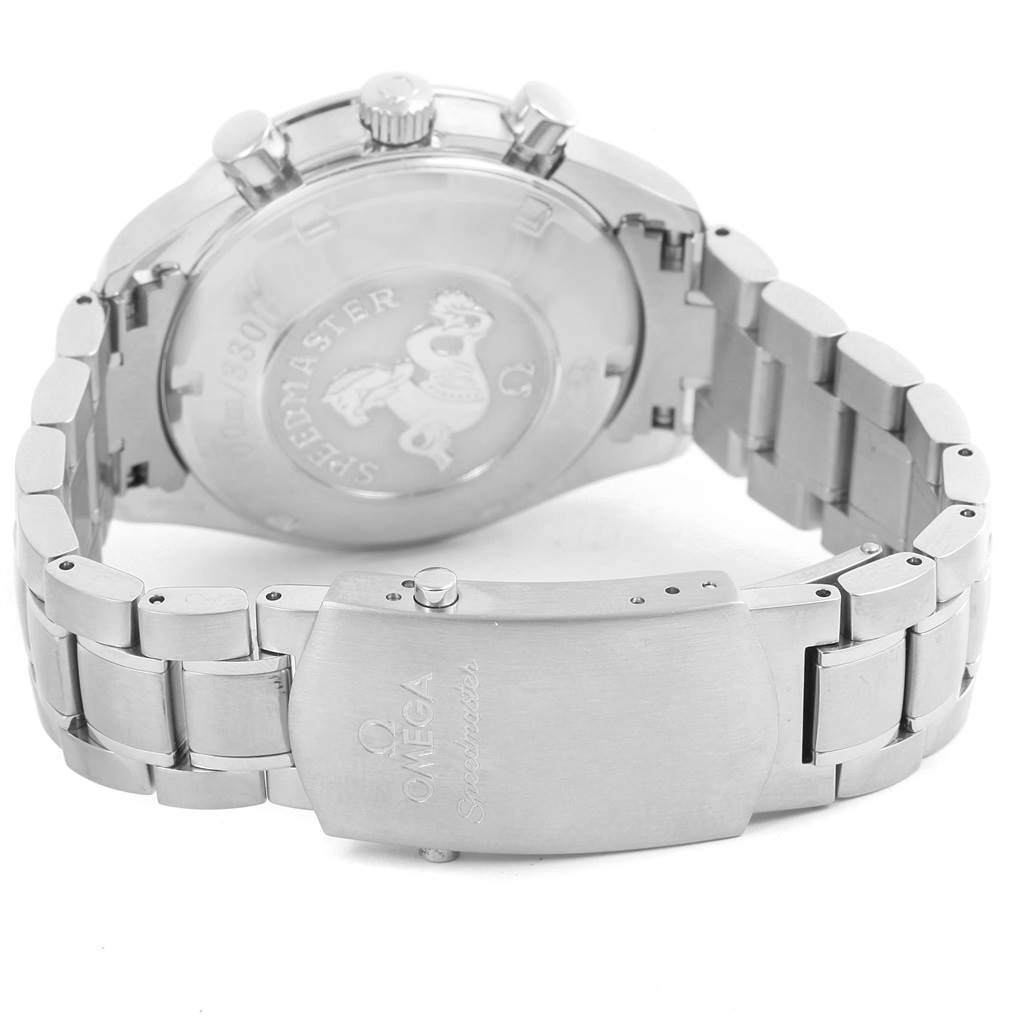 The image shows the backside and clasp of the Omega Speedmaster 3210.52.00 Men
s Stainless Steel Black Dial 3210.52.00 Men
s Stainless Steel Black Dial watch, highlighting the engraved case back and metal bracelet.