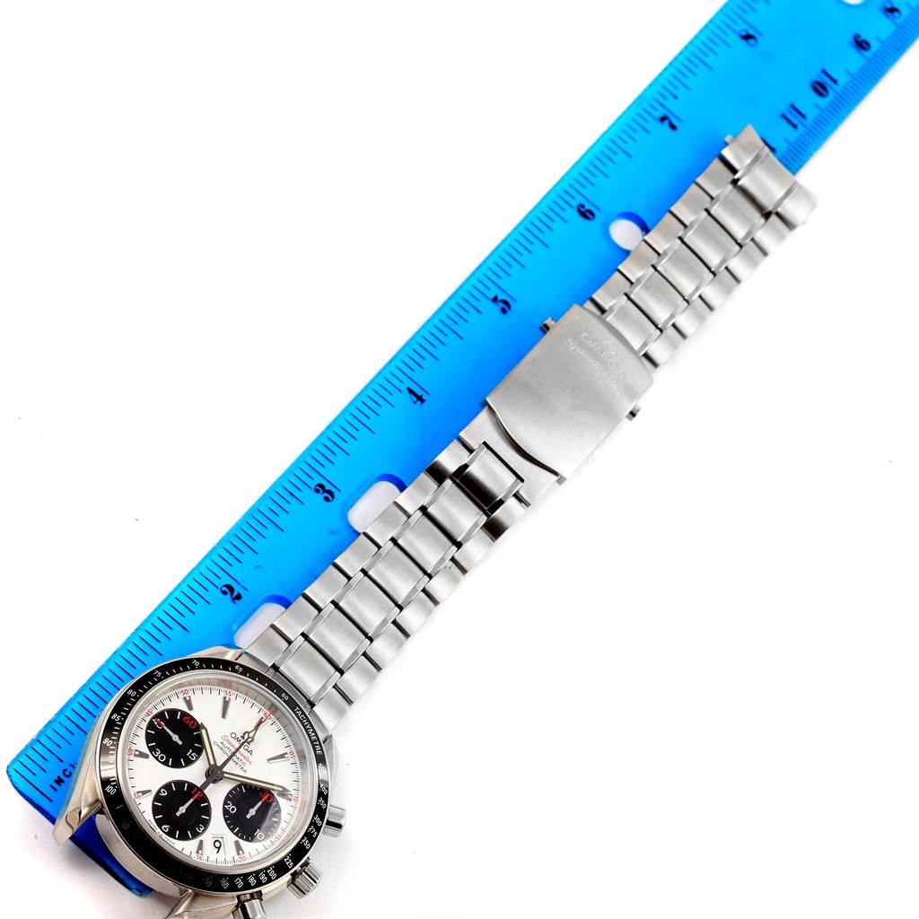 The Omega Speedmaster 323.30.40.40.04.001 Men
s Stainless Steel White Dial 323.30.40.40.04.001 Men
s Stainless Steel White Dial watch is shown from an overhead angle, highlighting its face and full metal bracelet alongside a ruler for size reference.