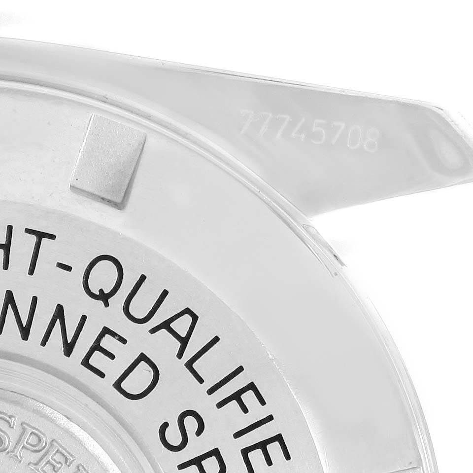 This close-up image shows part of the back cover of the Omega Speedmaster 3570.50.00 Men
s Stainless Steel Black Dial 3570.50.00 Men
s Stainless Steel Black Dial watch, including part of the inscription and a visible serial number.