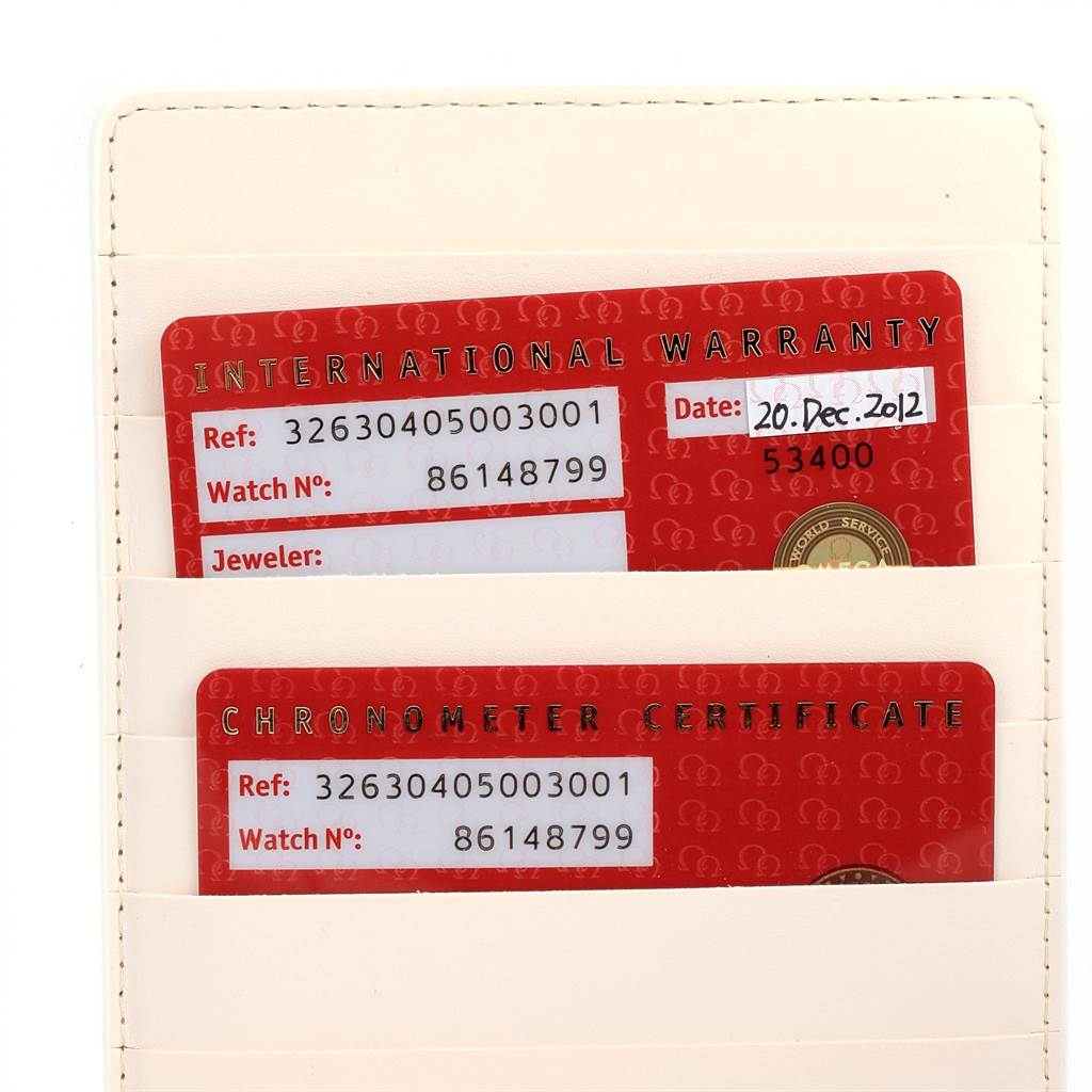 The image shows the International Warranty and Chronometer Certificate cards for an Omega Speedmaster 326.30.40.50.03.001 Men
s Stainless Steel Blue Dial 326.30.40.50.03.001 Men
s Stainless Steel Blue Dial watch.