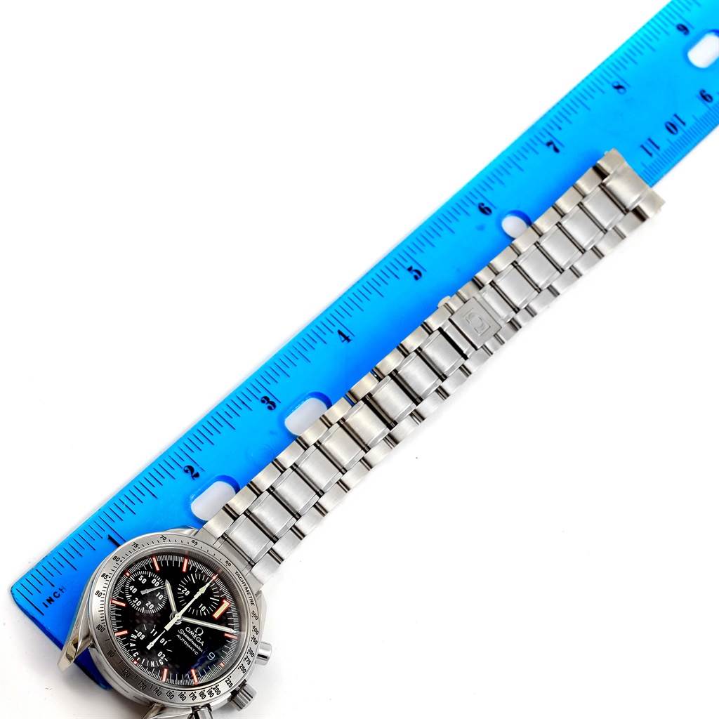 The Omega Speedmaster 3519.50.00 Men
s Stainless Steel Black Dial 3519.50.00 Men
s Stainless Steel Black Dial watch is shown from an overhead angle with its face and entire bracelet fully visible next to a ruler.