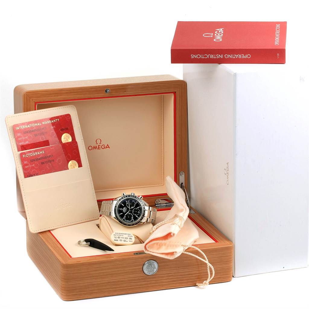 The image shows an Omega Speedmaster 326.30.40.50.01.001 Men
s Stainless Steel Black Dial 326.30.40.50.01.001 Men
s Stainless Steel Black Dial watch in a display box with warranty cards, instructions, a cloth, and a strap adjustment tool.
