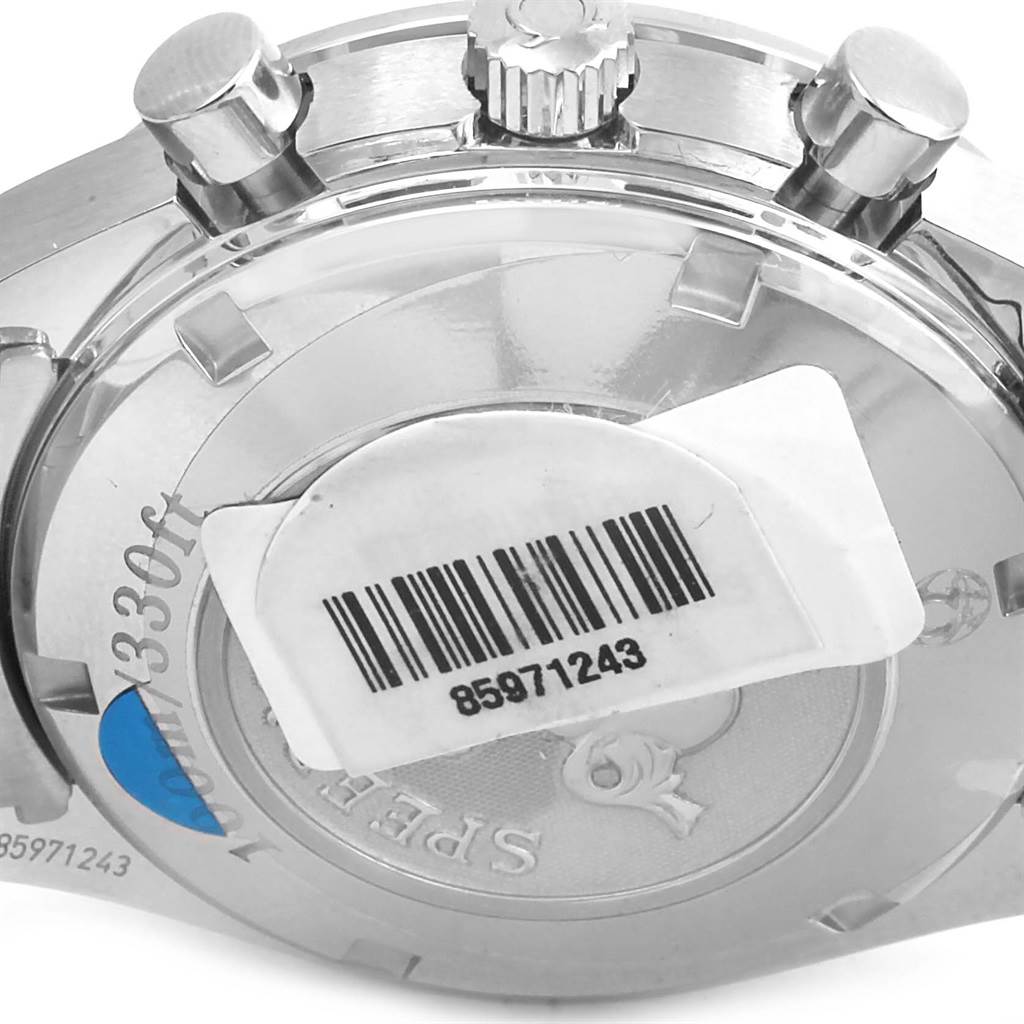The image shows the back case and crown of an Omega Speedmaster 323.30.40.40.06.001 Men
s Stainless Steel Grey Dial 323.30.40.40.06.001 Men
s Stainless Steel Grey Dial watch with a barcode sticker on it.