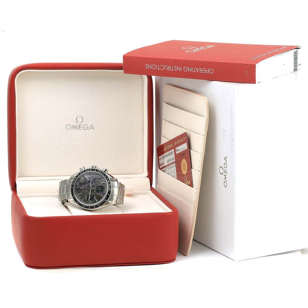 The Omega Speedmaster 323.30.40.40.06.001 Men
s Stainless Steel Grey Dial 323.30.40.40.06.001 Men
s Stainless Steel Grey Dial watch is presented in its box with an instruction manual and warranty cards visible.