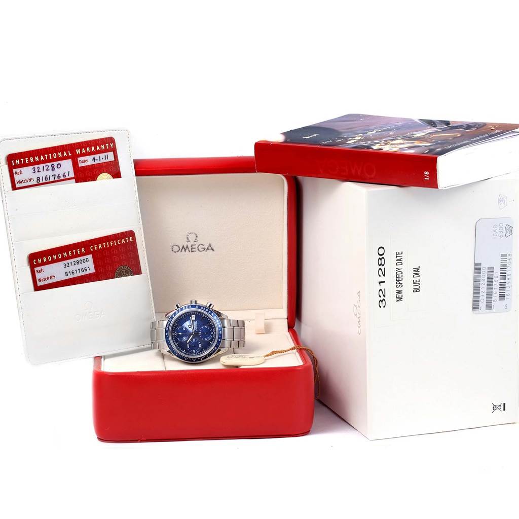 This image shows the Omega Speedmaster 3212.80.00 Men
s Stainless Steel Blue Dial 3212.80.00 Men
s Stainless Steel Blue Dial watch, its box, warranty cards, and an instruction manual.