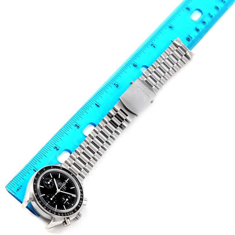The image shows an Omega Speedmaster 3539.50.00 Men
s Stainless Steel Black Dial 3539.50.00 Men
s Stainless Steel Black Dial watch, laid flat against a ruler, displaying its face and metal bracelet.