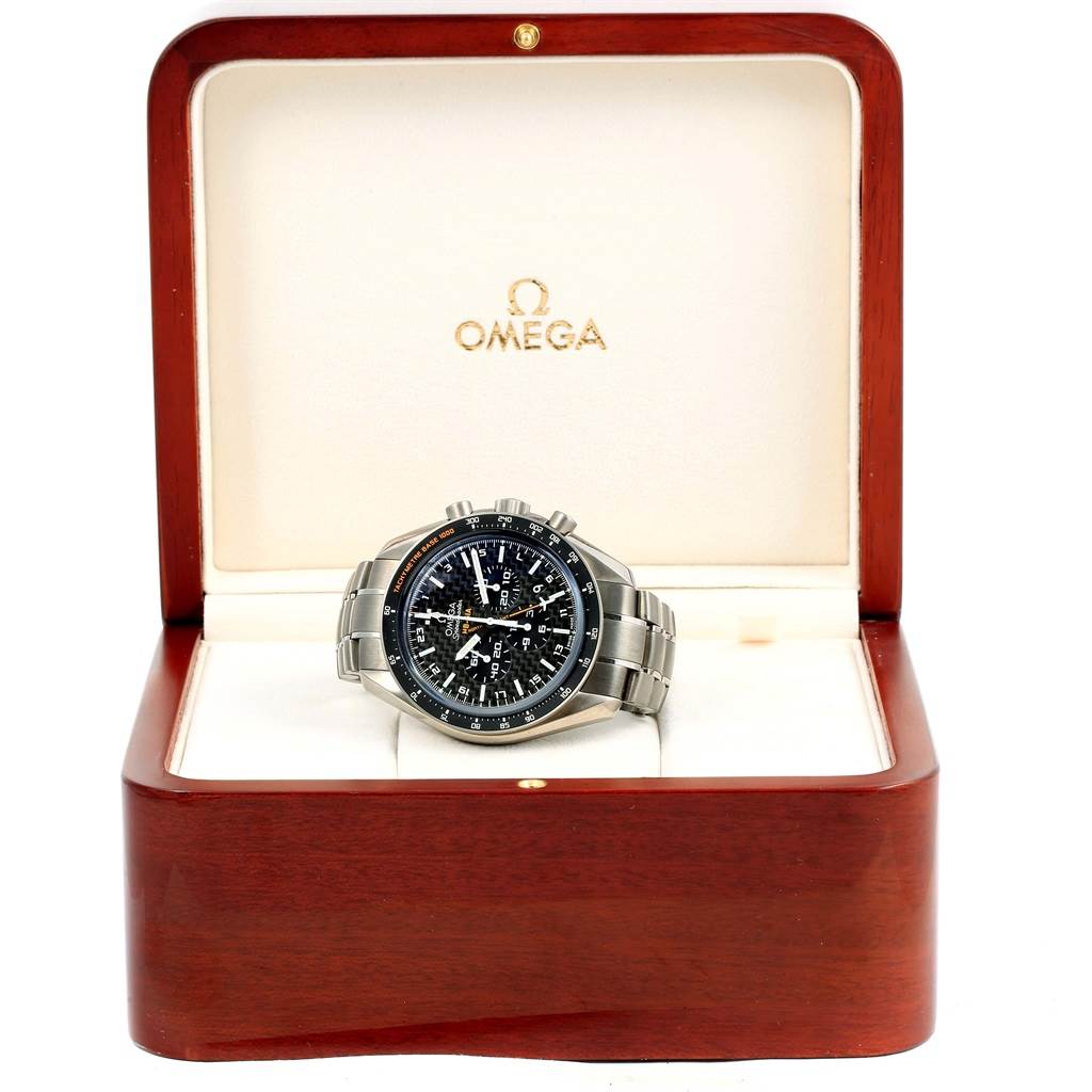 The Omega Speedmaster 321.90.44.52.01.001 Men's Titanium Black Dial 321.90.44.52.01.001 Men's Titanium Black Dial watch is displayed from the front in an open wooden box with a metal bracelet visible.