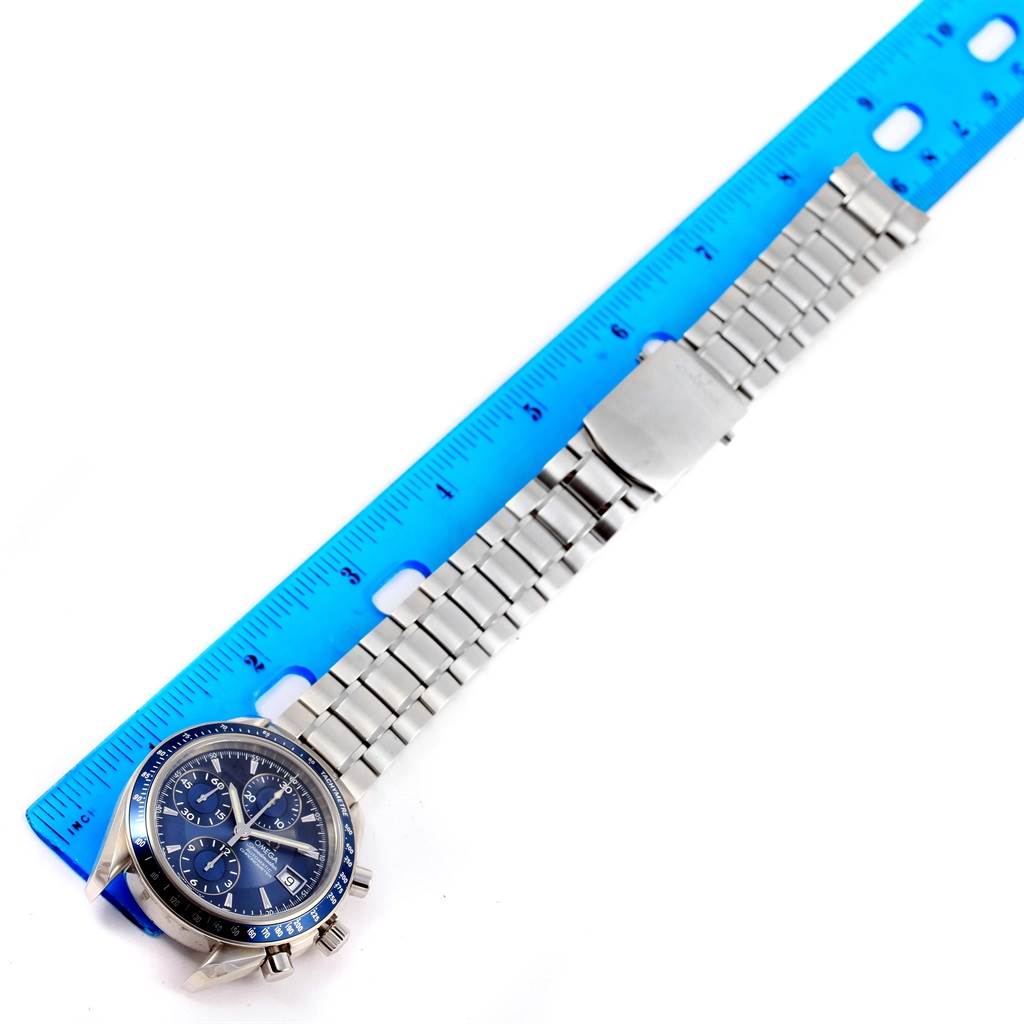 The Omega Speedmaster 3212.80.00 Men
s Stainless Steel Blue Dial 3212.80.00 Men
s Stainless Steel Blue Dial watch is shown from a diagonal angle with its full stainless steel bracelet and a blue ruler for scale.