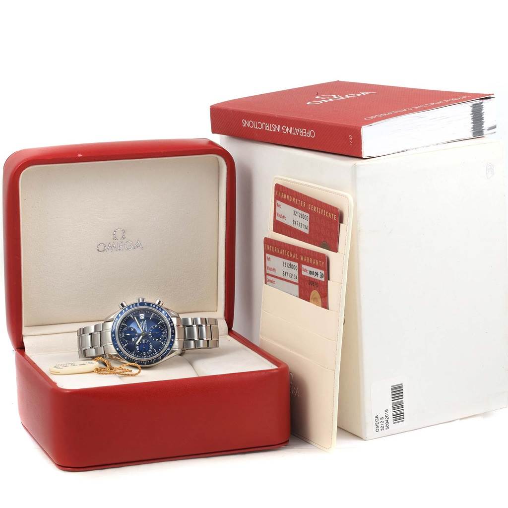 The image shows an Omega Speedmaster 3212.80.00 Men
s Stainless Steel Blue Dial 3212.80.00 Men
s Stainless Steel Blue Dial watch in its case, accompanied by certificates and operating instructions.
