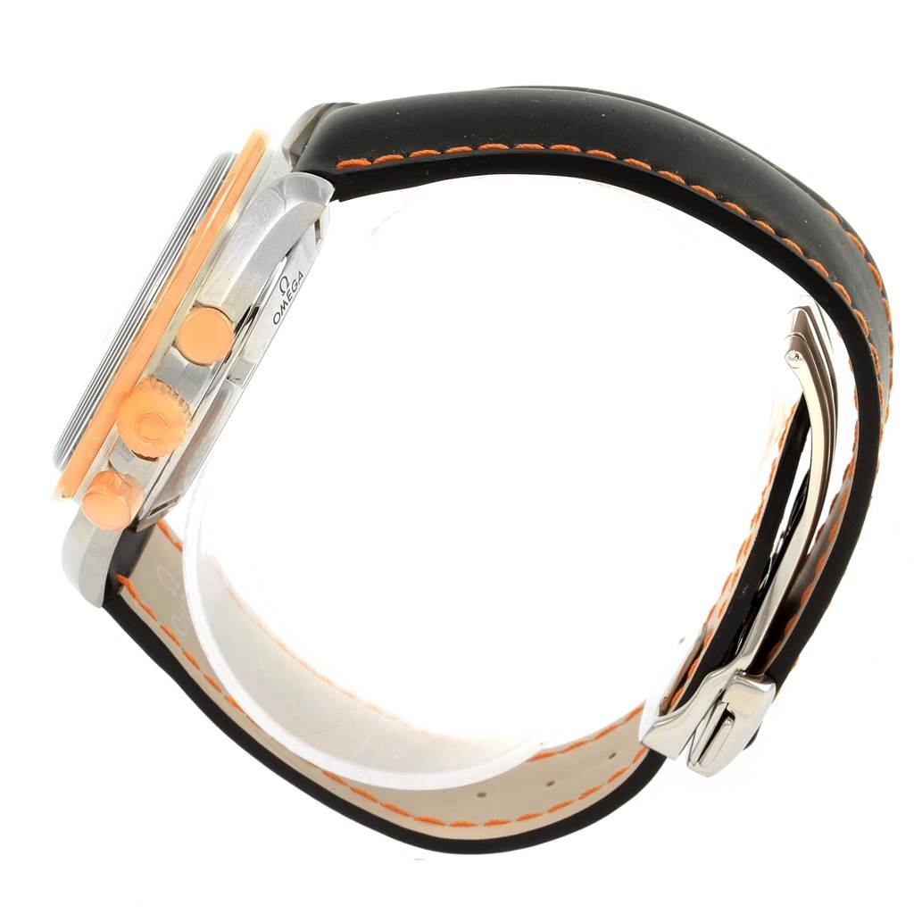 The image shows a side view of an Omega Speedmaster 321.93.42.50.13.001 Men
s Steel and Gold (two tone) Brown Dial 321.93.42.50.13.001 Men
s Steel and Gold (two tone) Brown Dial watch, highlighting its crown, pushers, and strap with orange stitching.