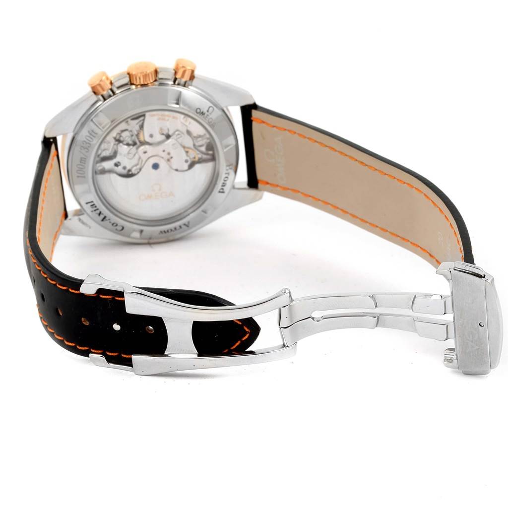 The image shows the back and side profile of an Omega Speedmaster 321.93.42.50.13.001 Men
s Steel and Gold (two tone) Brown Dial 321.93.42.50.13.001 Men
s Steel and Gold (two tone) Brown Dial, highlighting the transparent case back and black leather strap with orange stitching.