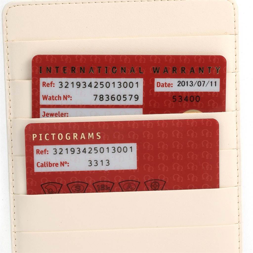 The image shows the warranty and pictograms cards for the Omega Speedmaster 321.93.42.50.13.001 Men
s Steel and Gold (two tone) Brown Dial 321.93.42.50.13.001 Men
s Steel and Gold (two tone) Brown Dial, placed in a cardholder.