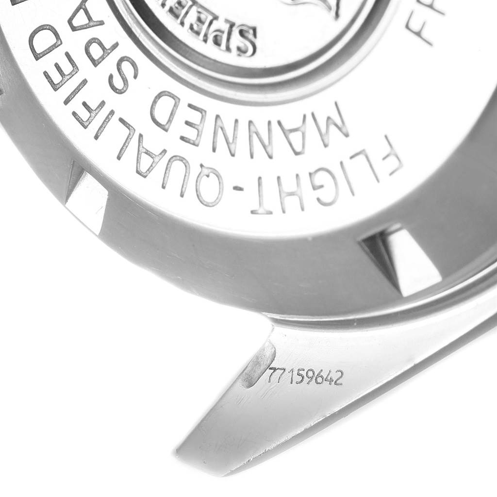 This image shows the back of the Omega Speedmaster 3577.50.00 Men's Stainless Steel Black Dial 3577.50.00 Men's Stainless Steel Black Dial watch at an angle, highlighting the engraved text and serial number.