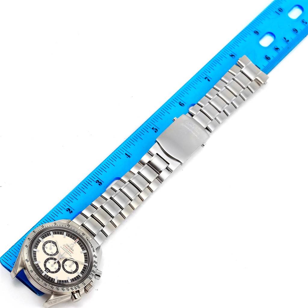 The Omega Speedmaster 3506.31.00 Men's Stainless Steel Silver Dial 3506.31.00 Men's Stainless Steel Silver Dial watch is shown from an overhead angle, displaying its full length, dial face, and metal bracelet with a clasp next to a ruler for scale.