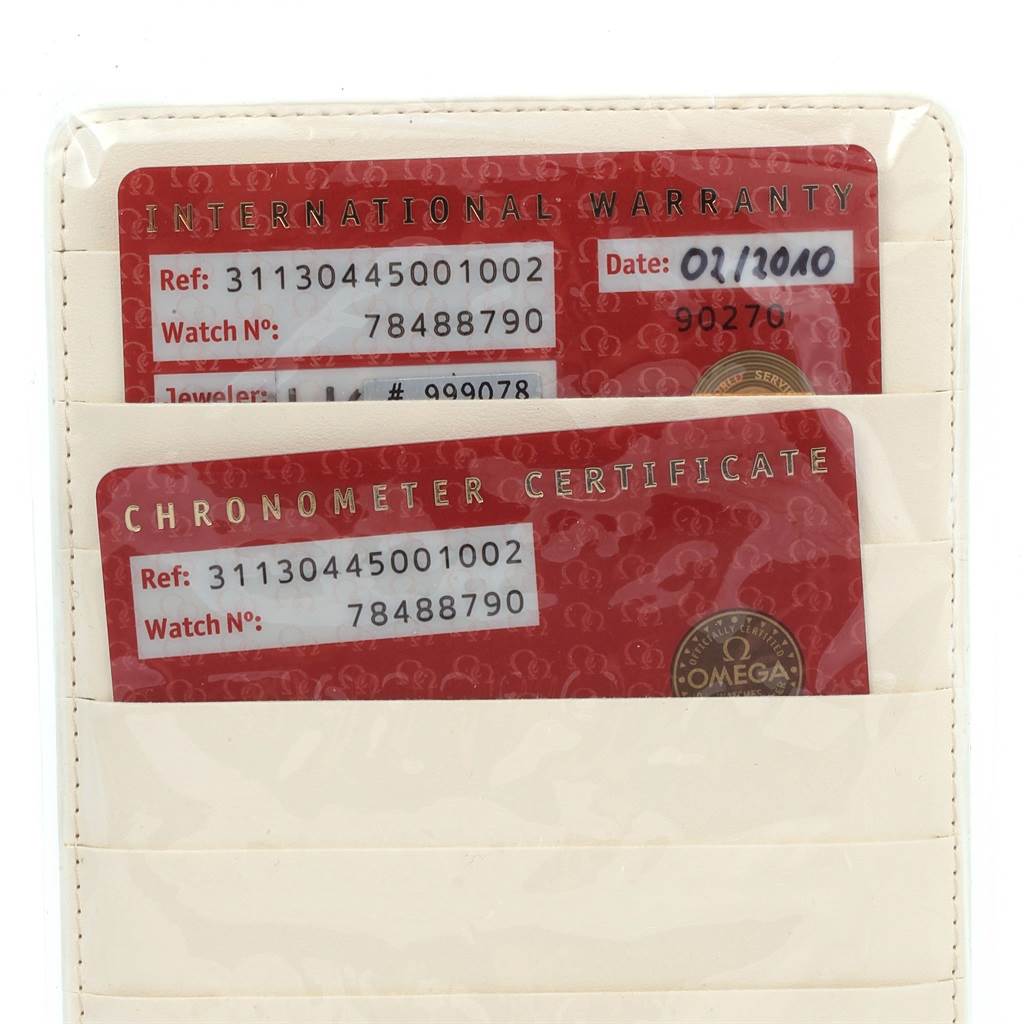 The image shows the warranty and chronometer certificate cards for the Omega Speedmaster 311.30.44.50.01.002 Men
s Stainless Steel Black Dial 311.30.44.50.01.002 Men
s Stainless Steel Black Dial watch.