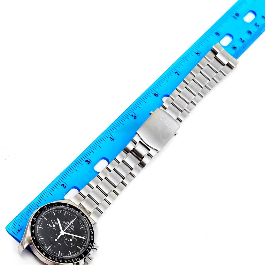 The image shows an Omega Speedmaster 311.30.44.50.01.002 Men
s Stainless Steel Black Dial 311.30.44.50.01.002 Men
s Stainless Steel Black Dial watch with a ruler, displaying its dial and stainless steel bracelet from a top-down angle.