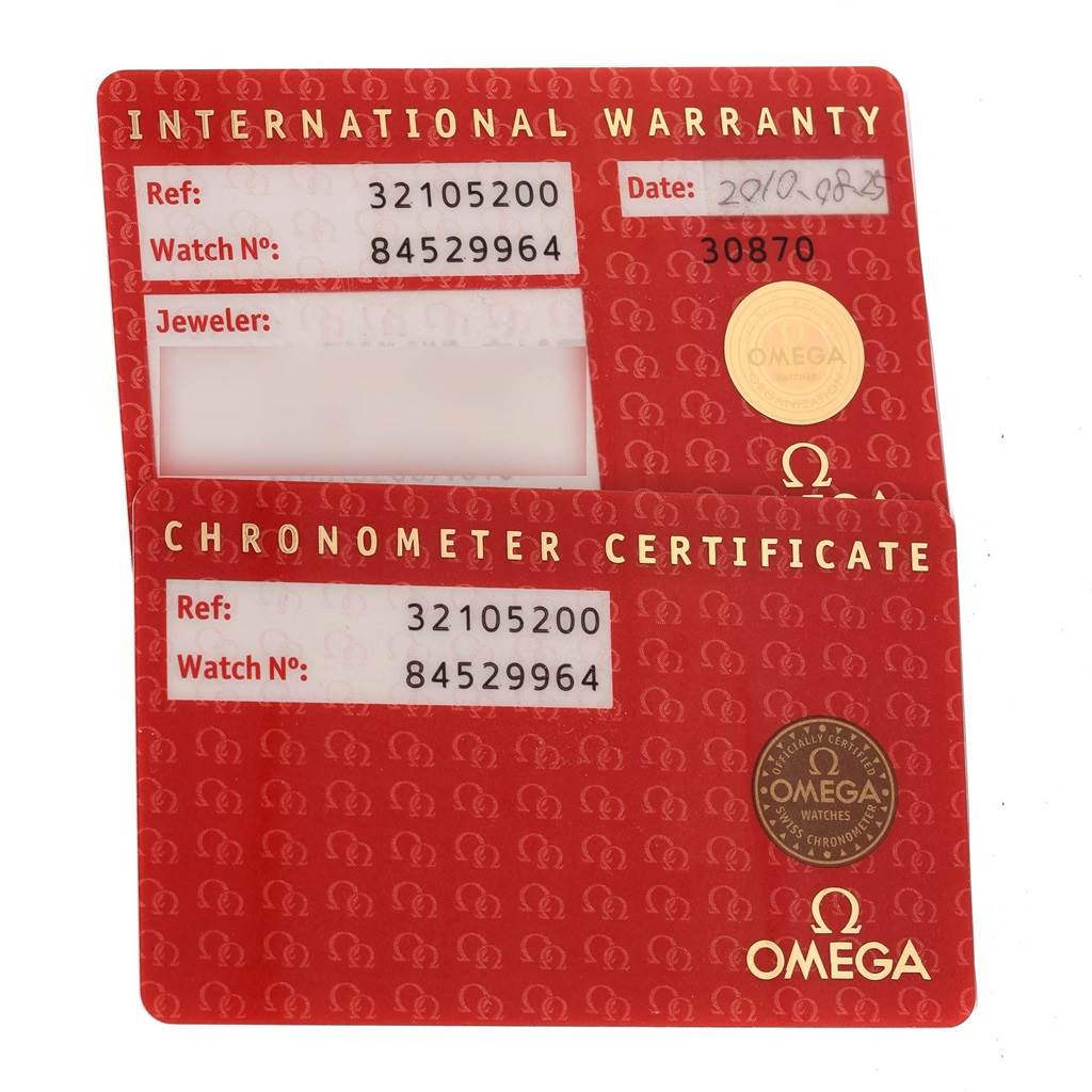 The image shows two red cards: an International Warranty and a Chronometer Certificate for the Omega Speedmaster 3210.52.00 Men
s Stainless Steel Black Dial 3210.52.00 Men
s Stainless Steel Black Dial.