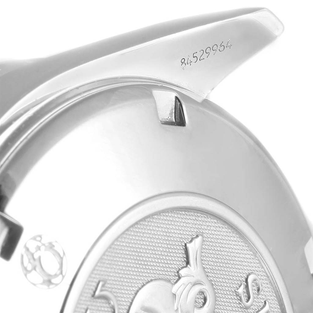 The image shows the back case and serial number of an Omega Speedmaster 3210.52.00 Men
s Stainless Steel Black Dial 3210.52.00 Men
s Stainless Steel Black Dial watch, viewed from a close-up angle.