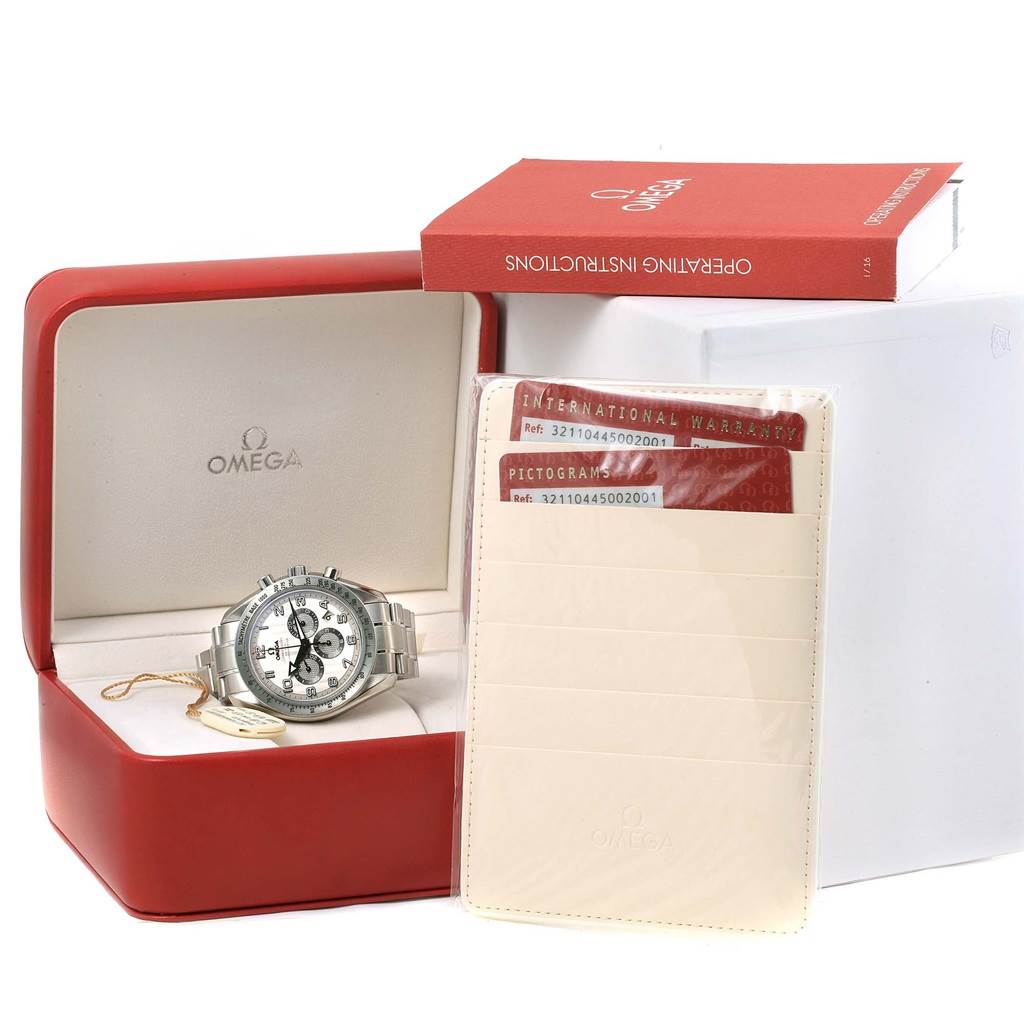 The Omega Speedmaster 321.10.44.50.02.001 Men's Stainless Steel Silver Dial 321.10.44.50.02.001 Men's Stainless Steel Silver Dial watch is shown with its box, international warranty cards, and operating instructions.