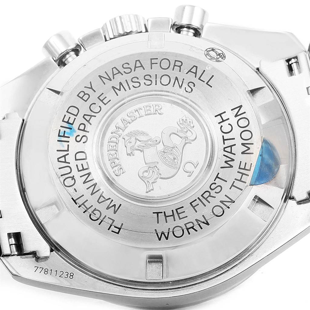 This image shows the back case and pushers of an Omega Speedmaster 311.30.42.30.01.005 Men
s Stainless Steel Black Dial 311.30.42.30.01.005 Men
s Stainless Steel Black Dial, with inscriptions highlighting its NASA qualification and moon landing heritage.