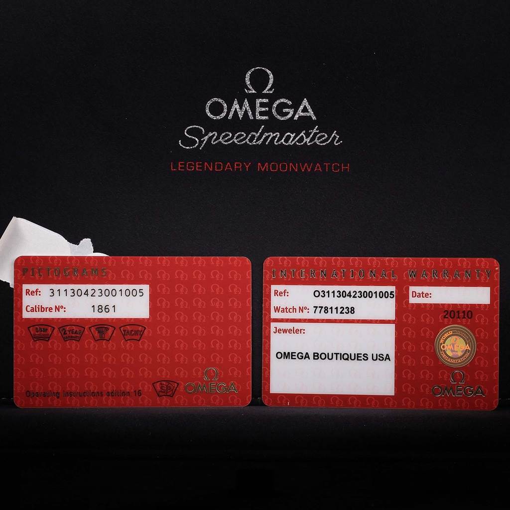 The image shows warranty and pictogram cards for the Omega Speedmaster 311.30.42.30.01.005 Men
s Stainless Steel Black Dial 311.30.42.30.01.005 Men
s Stainless Steel Black Dial watch.