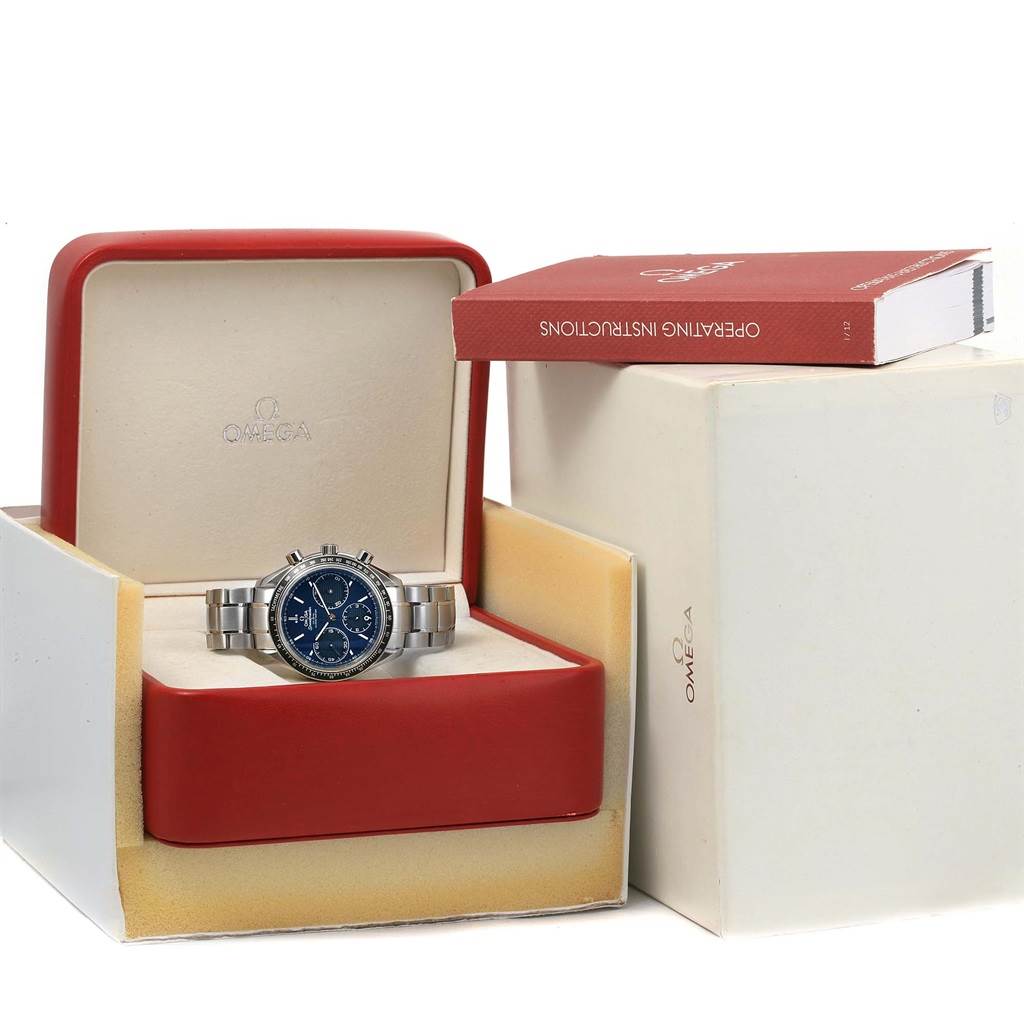 The Omega Speedmaster 326.30.40.50.03.001 Men
s Stainless Steel Blue Dial 326.30.40.50.03.001 Men
s Stainless Steel Blue Dial watch is shown in its open box with its operating instructions placed outside the box.