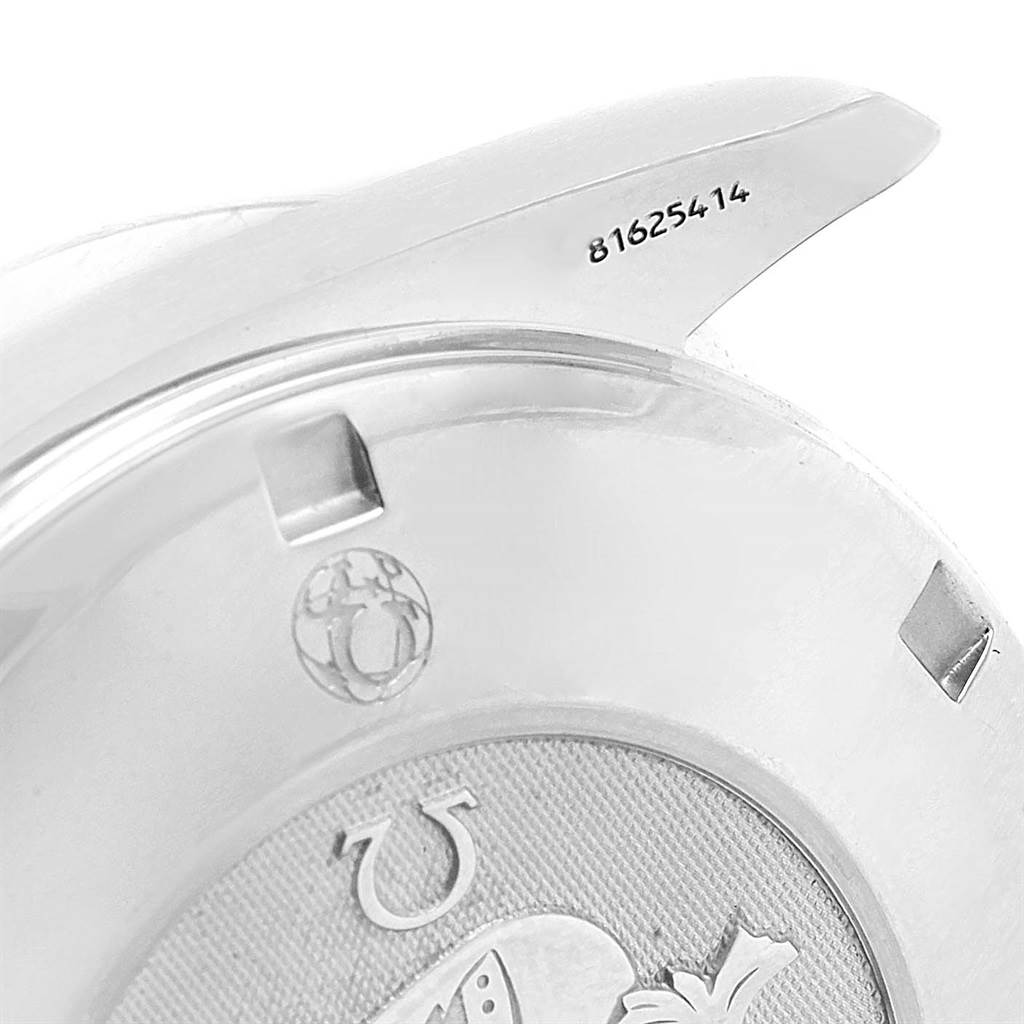 The image shows the back case and one lug of an Omega Speedmaster 3211.31.00 Men
s Stainless Steel Silver Dial 3211.31.00 Men
s Stainless Steel Silver Dial watch with the serial number visible.