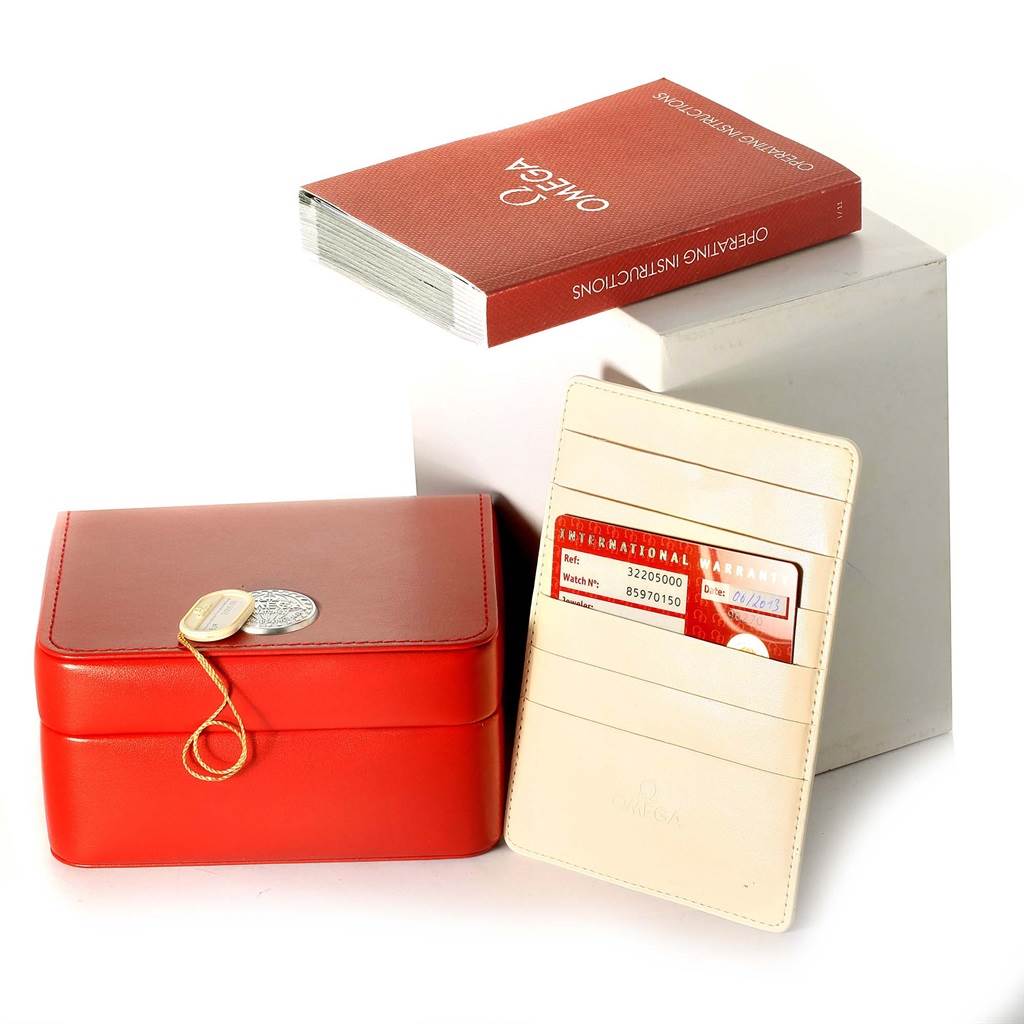 The image shows the packaging, warranty card holder, and instruction booklet for an Omega Speedmaster 3220.50.00 Men
s Stainless Steel Black Dial 3220.50.00 Men
s Stainless Steel Black Dial watch.