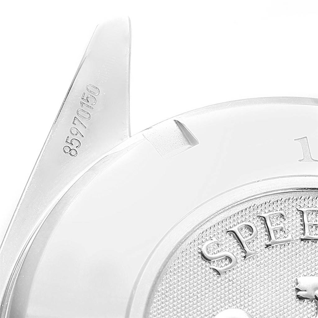 The image shows a close-up of the Omega Speedmaster 3220.50.00 Men
s Stainless Steel Black Dial 3220.50.00 Men
s Stainless Steel Black Dial watch case back and a portion of the lugs with a serial number.