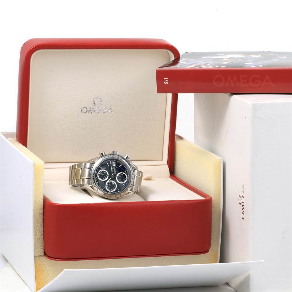 The Omega Speedmaster 3513.46.00 Men
s Stainless Steel Blue Dial 3513.46.00 Men
s Stainless Steel Blue Dial watch is shown front-facing in its open red box, with an Omega booklet placed beside it.