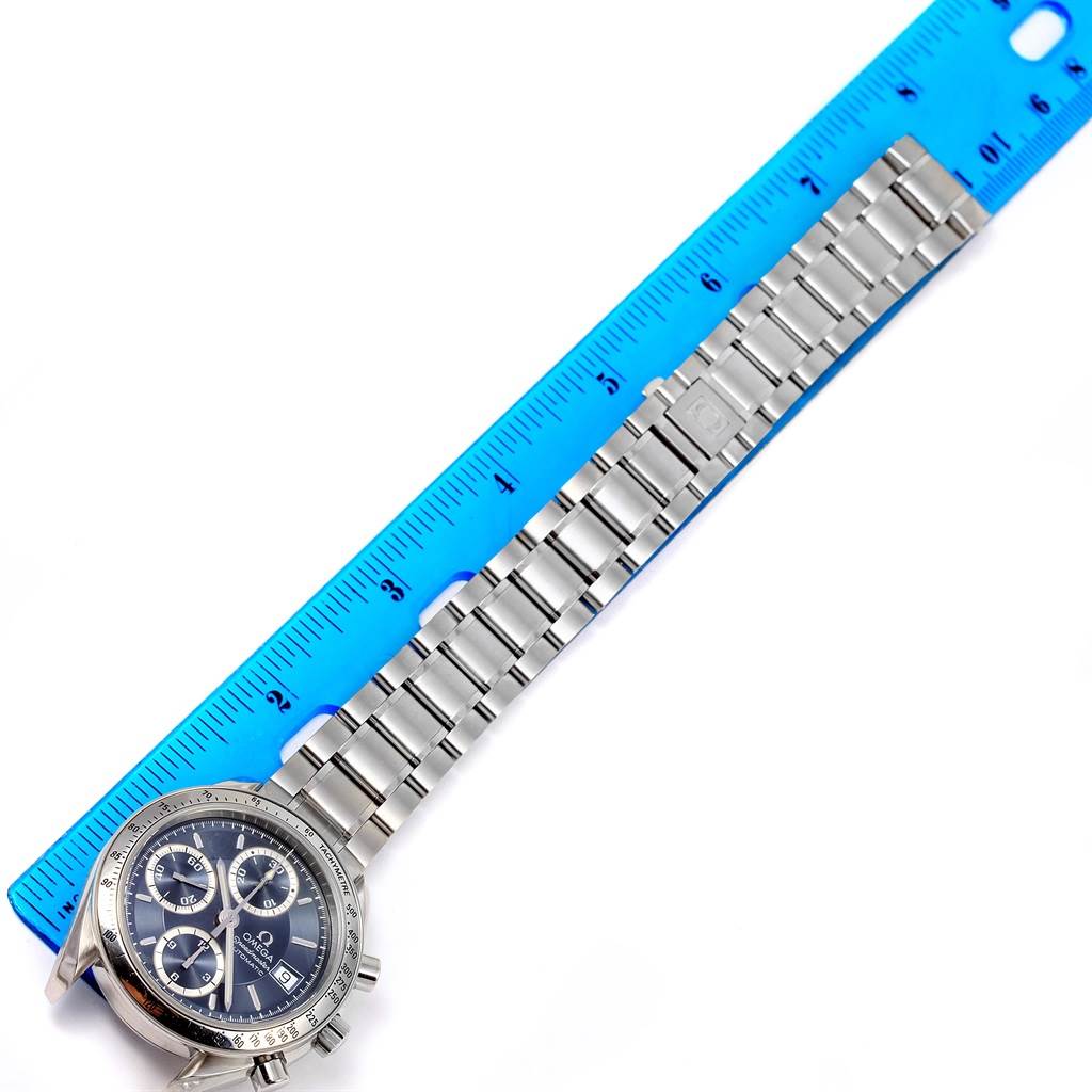 The image shows the Omega Speedmaster 3513.46.00 Men
s Stainless Steel Blue Dial 3513.46.00 Men
s Stainless Steel Blue Dial watch lying flat beside a ruler, displaying the watch face and bracelet links.