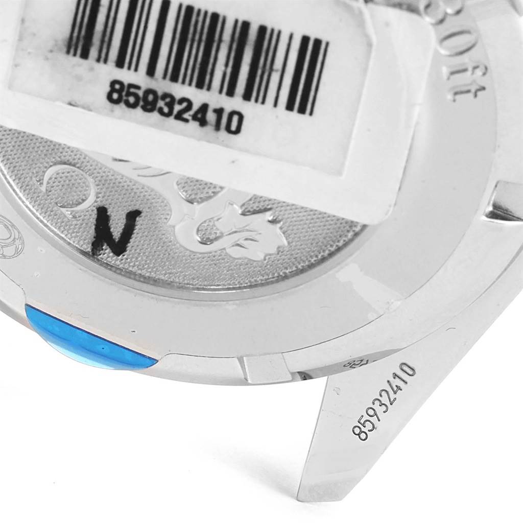 The image shows the back of the Omega Speedmaster 3220.50.00 Men
s Stainless Steel Black Dial 3220.50.00 Men
s Stainless Steel Black Dial watch case, featuring a barcode sticker and engraved serial number.