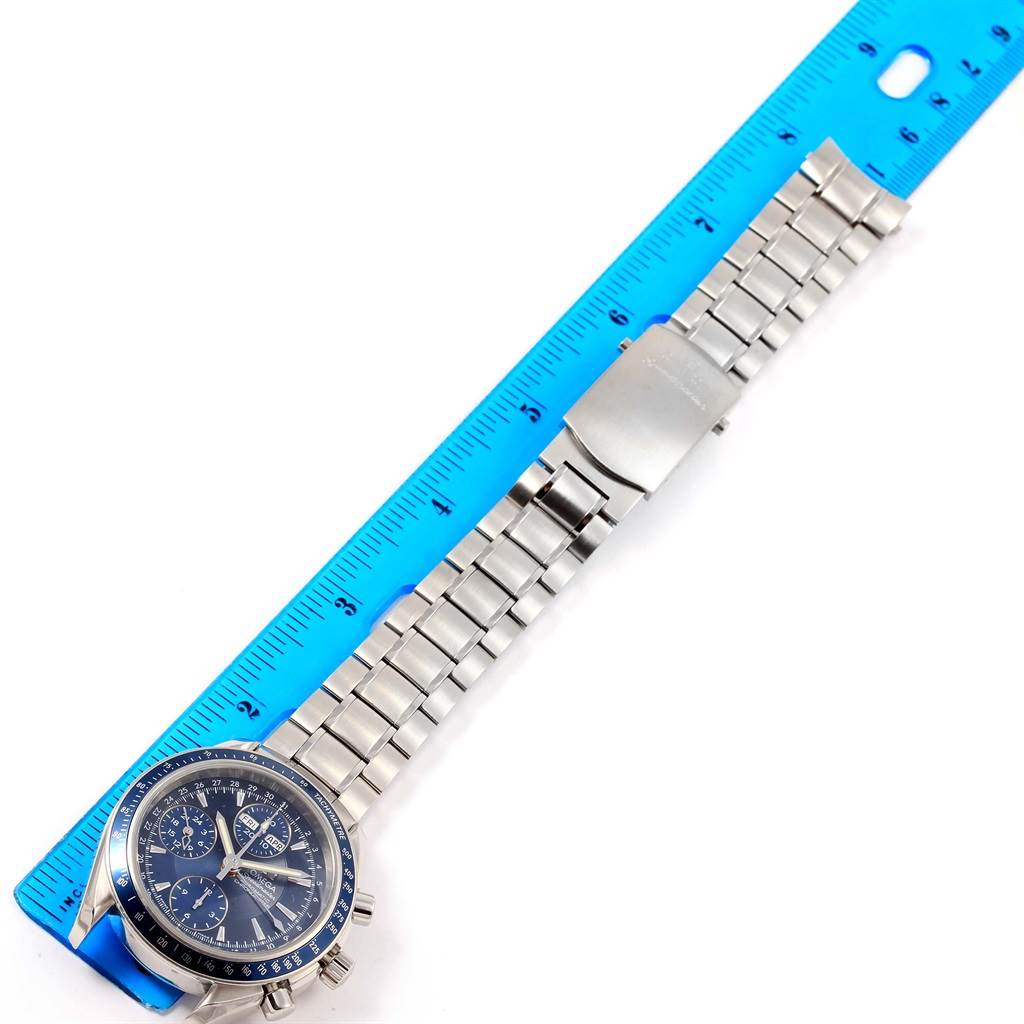 The Omega Speedmaster 3222.80.00 Men
s Stainless Steel Blue Dial 3222.80.00 Men
s Stainless Steel Blue Dial watch is shown from a top-down angle, displaying the full length of its strap with a ruler for scale.