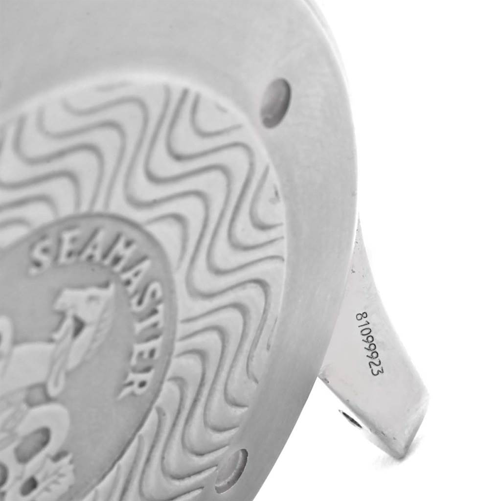 This close-up image shows the case back of the Omega Seamaster watch, displaying part of its distinctive wave pattern and engraved details.
