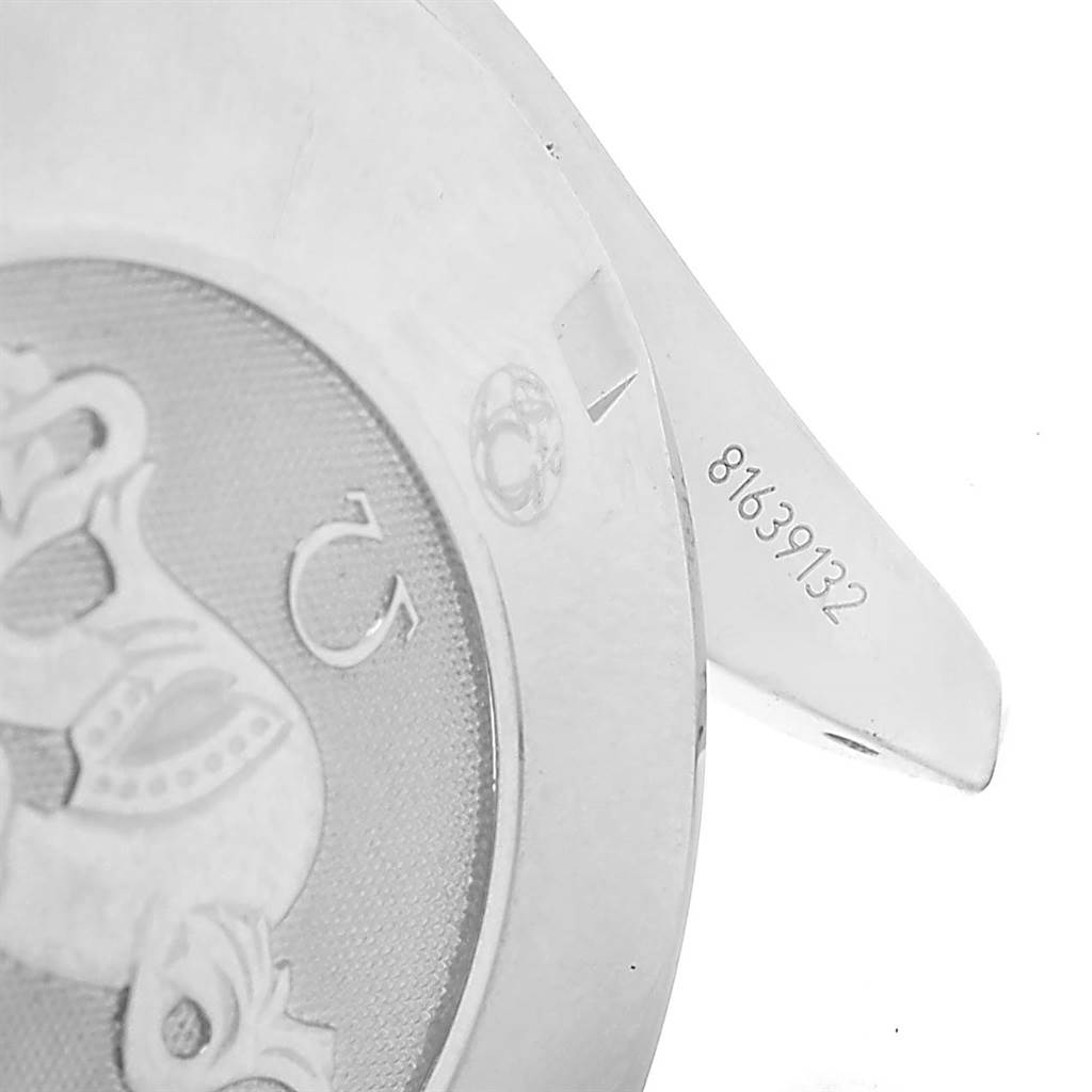 The image shows the back of an Omega Speedmaster 3210.52.00 Men
s Stainless Steel Black Dial 3210.52.00 Men
s Stainless Steel Black Dial watch, highlighting partial case back engravings and a visible serial number.