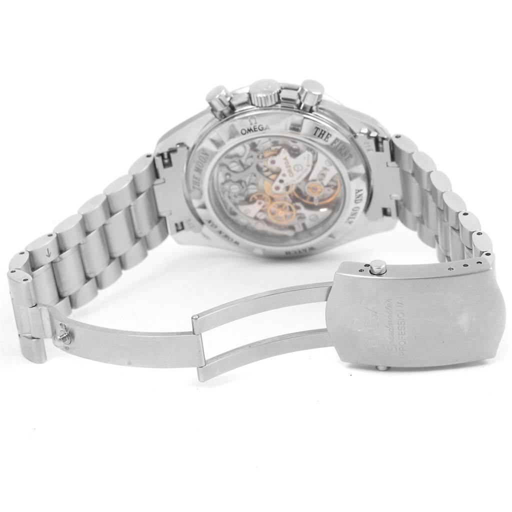 The image shows the back and partially open clasp of an Omega Speedmaster 3573.50.00 Men's Stainless Steel Black Dial 3573.50.00 Men's Stainless Steel Black Dial watch, highlighting its mechanical movement and metal bracelet.